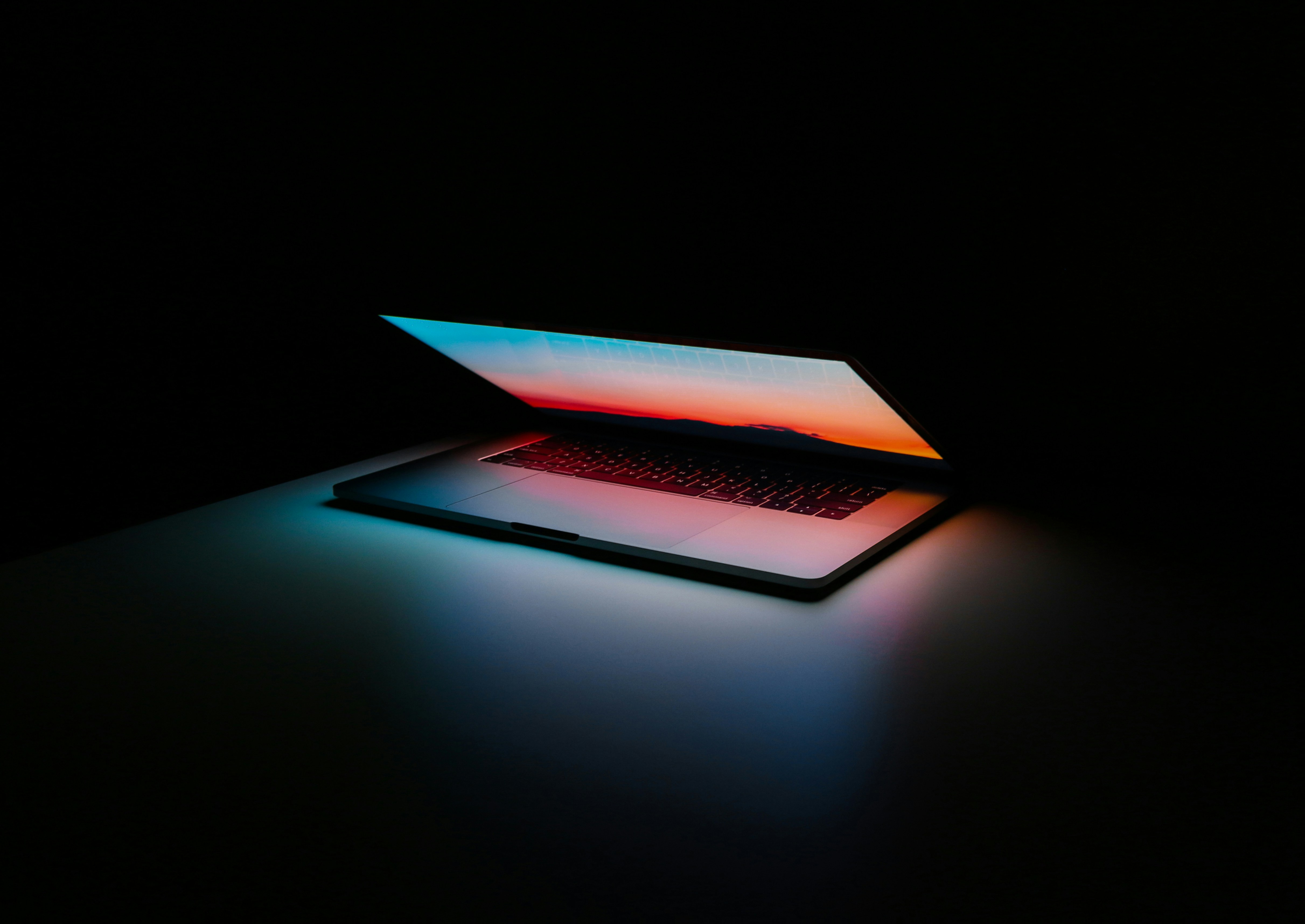 Background image of a laptop with code